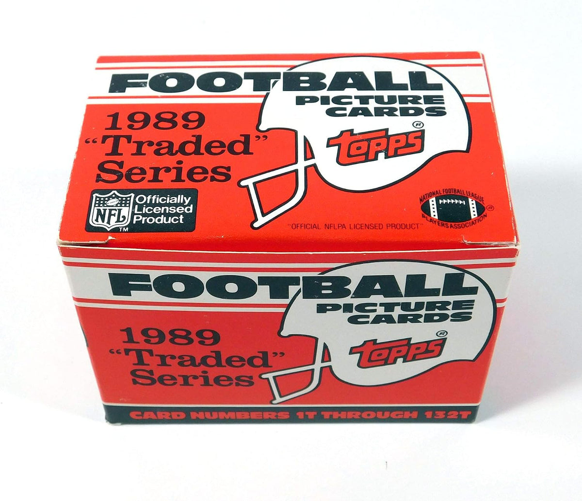 1989 Topps Traded Football Complete Mint 132 Card Set in Original Factory Set Box. Featuring Rookie Cards of Barry Sanders, Troy Aikman, Derrick Thomas, Deion Sanders and Many Others!